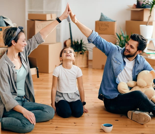 Homem e mulher fazendo um telhado com as mãos por cima de uma criança