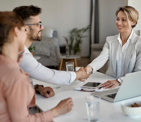 Homem e mulher se cumprimentam apertando as mãos
